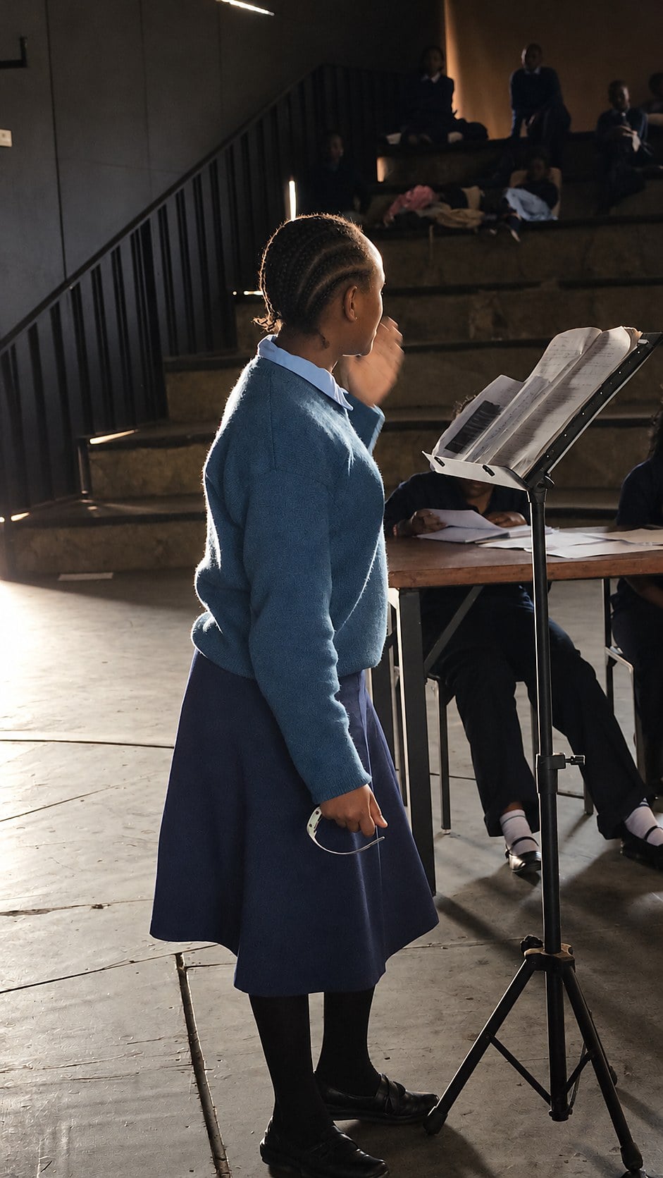 A student in school uniform speaking to her classmates during a NenaHub club session